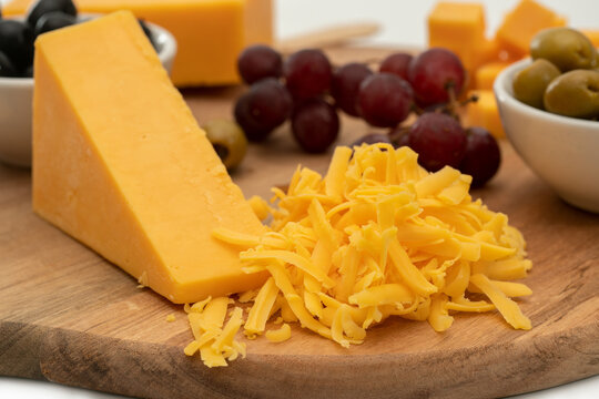 cheddar cheese with grater and grapes