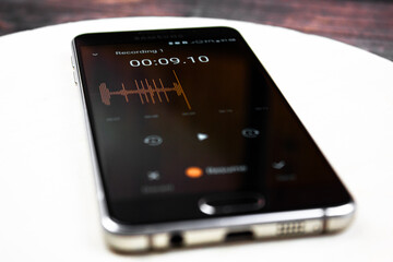 Voice recorder on a smartphone. Voice recording wave on the screen of a smartphone. Recording...