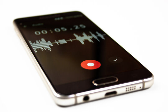 Voice recorder on a smartphone. Voice recording wave on the screen of a smartphone. Recording sounds on a smartphone. Voice recorder noise level wave.