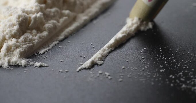 crystal drug use, sniff white cocaine amphetamine through a bill. High quality 4k footage