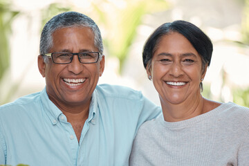 Obraz premium Smile, happy or bonding mature couple in house or home garden in trust, security and love marriage. Portrait of retirement, elderly or senior man and woman sitting together and laughing at funny joke