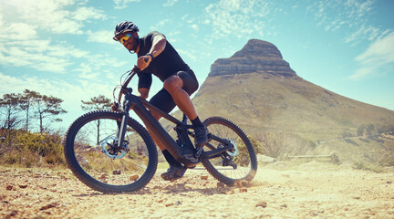 Fototapeta na wymiar Mountain bike, fitness and exercise man off road, dirt road or sand by Lions head mountain. Health, wellness and male on desert, dust or terrain track on bicycle training for cycling race in nature.