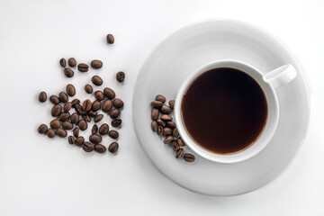 Cup of coffee and coffee beans, flat lay.