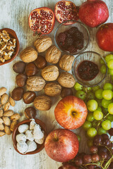 Autumn fruit background.
Autumnal fruit table. Grapes, figs, blackberries, passion fruit, pomegranate and delicious dried fruits.