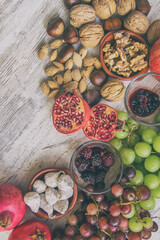 Autumn fruit background.
Autumnal fruit table. Grapes, figs, blackberries, passion fruit, pomegranate and delicious dried fruits. Image with copy space