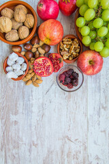 Autumn fruit background.
Autumnal fruit table. Grapes, figs, blackberries, passion fruit, pomegranate and delicious dried fruits. Image with copy space