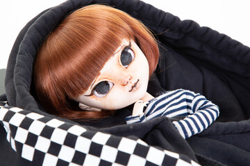 Portrait doll girl in a black fashion child checkered sweat cap