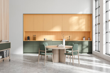 Bright kitchen interior with dining table and seats, drawer and panoramic window