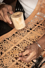 craft artist making traditional buffalo leather carving art in indonesia
