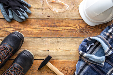 Set of repair tools and work uniform on wooden background, flat lay.