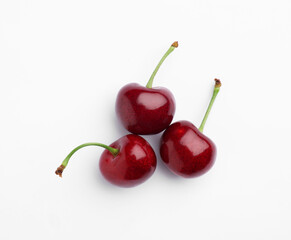 Ripe sweet cherries on white background, top view