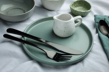 Stylish empty dishware and cutlery on table, closeup