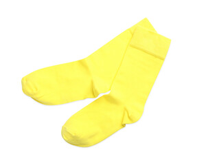 Pair of yellow socks on white background, top view