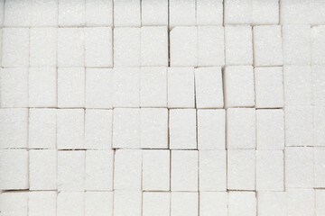 White sugar cubes as background, top view