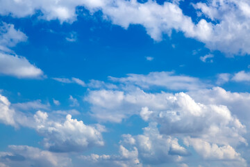 Fantastic soft white clouds against blue sky background, soft focus lens flare sunlight. Sunshine clouds sky during morning background. Abstract blurred gradient of peaceful nature. View out windows