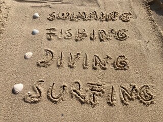 In the sand are listed vacation activities