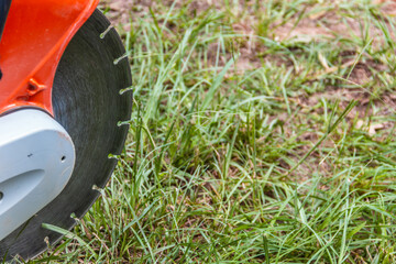 Close-up shot of a stone-cutting demo saw blade sitting on the ground
