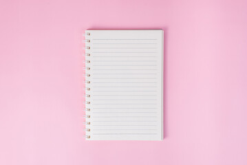 Top view image of notebook on pink background