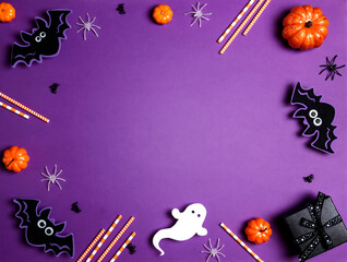 Halloween purple background with bats, spiders, pumpkins and gift.