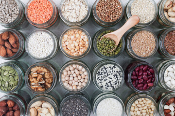 Vegan protein source. assortment of healthy vegetarian food. top view of seeds, nuts, peas, beans, rice, spelt, oatmeal on white background
