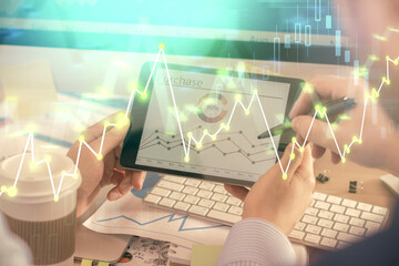 Fototapeta premium Double exposure of man's hands holding and using a phone and financial chart drawing. Market analysis concept.