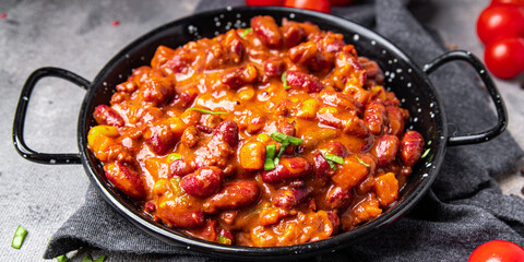 Сhili con carne bean, corn, meat, tomato sauce healthy meal food snack on the table copy space food background 