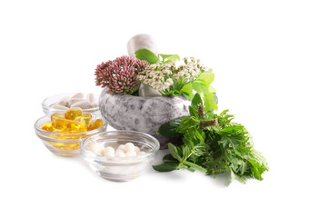 Marble mortar with fresh herbs and pills on white background