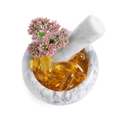 Mortar with flowers and pills on white background, top view