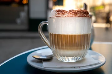 Foto op Plexiglas Closeup of cappuccino in a cup with creamy topping in a sidewalk cafe in Paris, France © Tilt&flow/Wirestock Creators