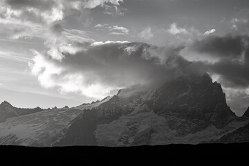 A black and white view of La Meije mountain on the sunrise