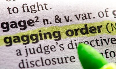Obraz premium Photo of the words gagging order in a dictionary book