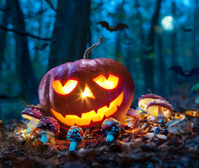 Carved pumpkins for Halloween jack-o'-lanterns with scary smiles to ward ofа evil spirits on mystery forest background.