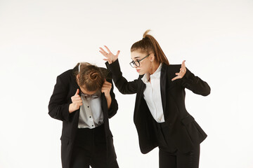 The conflict of two girls in office clothes. Boss and subordinate. Pure white background. The...