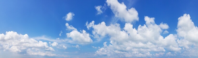 Naklejka na ściany i meble White cumulus clouds on clear blue sky background panorama, beautiful cloudscape wide panoramic view, cloudy skies backdrop, fluffy cloud texture, sunny summer day heaven landscape, cloudiness weather