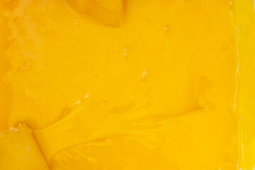 Light yellow surface of ripe natural Bashkir bee honey. Abstract texture, background.
