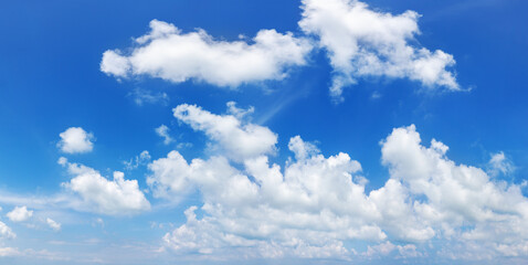 Naklejka na ściany i meble White cumulus clouds on clear blue sky background panorama, beautiful cloudscape wide panoramic view, cloudy skies backdrop, fluffy cloud texture, sunny summer day heaven landscape, cloudiness weather