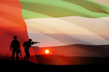 Fototapeta na wymiar Silhouettes of soldiers on background of UAE flag and the sunset or the sunrise. Concept of national holidays. Commemoration Day.