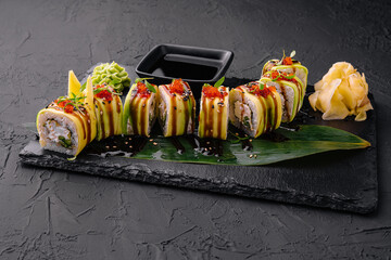 Sushi cheese rolls on black slate