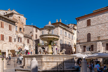 Fototapeta premium The ancient fountain of the three lions, Piazza del Comune square, Assisi, Perugia, Italy