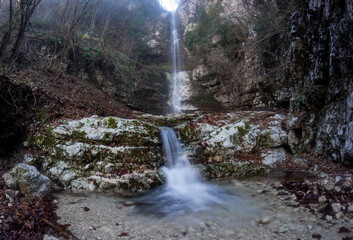 Waterfall of quadrelle in mountain gorge