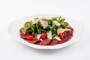 Meat carpaccio with arugula and parmesan cheese