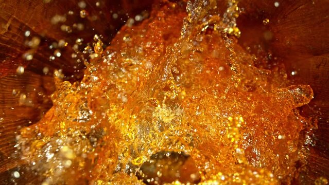 Super slow motion of pouring whiskey, rum or cognac inside the barrel. Filmed on high speed cinema camera, 1000fps. Ultimate composition view inside the wooden keg. Speed ramp effect.