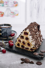 Triangle cherry cake with cream and chocolate sprinkles