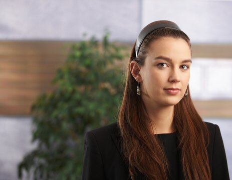 Portrait of serious young businesswoman at office.