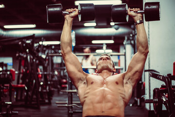 Fototapeta premium Man working out with dumbbells