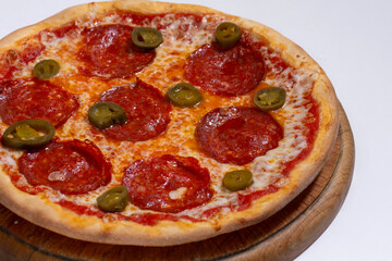 Closeup of pizza with pepperoni and jalapeno pepper