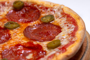 Closeup of pizza with pepperoni and jalapeno pepper