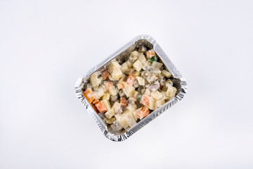 Olivier salad served in aluminium tray