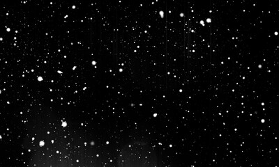 Falling snow at night. Bokeh lights on black background, flying snowflakes in the air. Overlay...