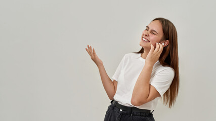 Girl enjoy of listen music in wireless earphones © Svitlana